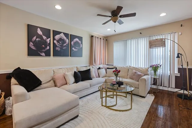 a living room with furniture and wooden floor