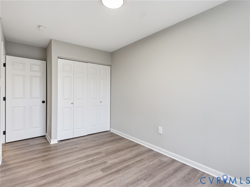 3518 East Richmond Road, Unit U3 Richmond, VA 23223 - Photo 17 of 19 a view of an empty room with wooden floor