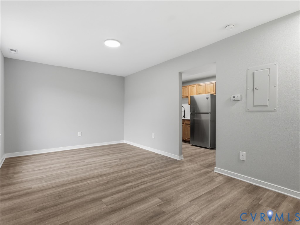 3518 East Richmond Road, Unit U3 Richmond, VA 23223 - Photo 6 of 19 a view of an empty room with wooden floor and a window