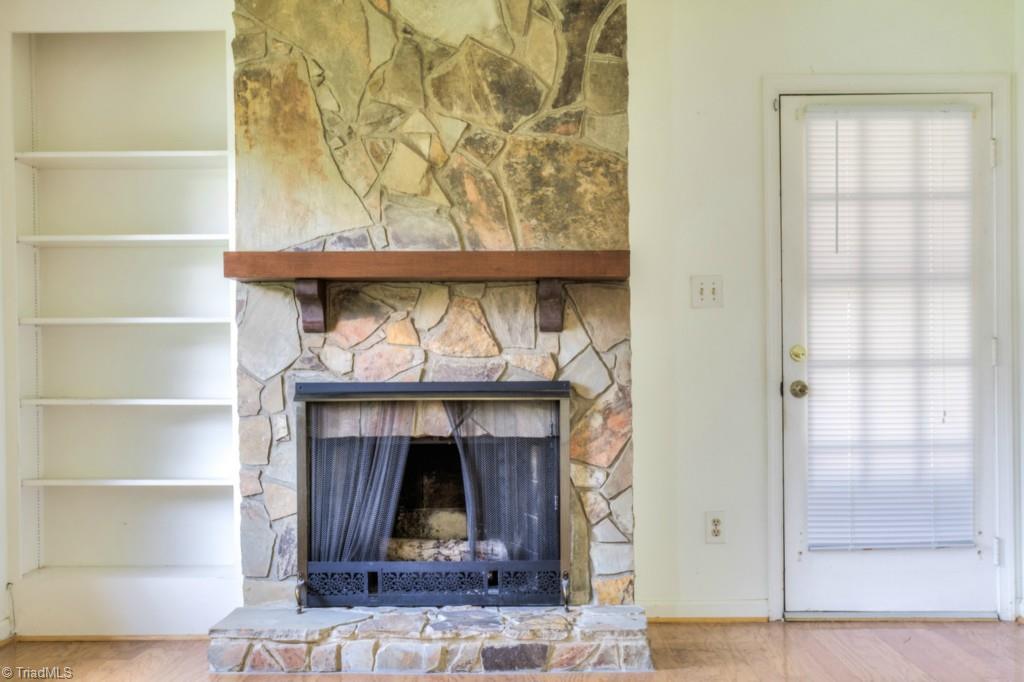 4924 Tower Road, Unit D Greensboro, NC 27410 - Photo 15 of 19 wood burning fireplace, door to covered patio.