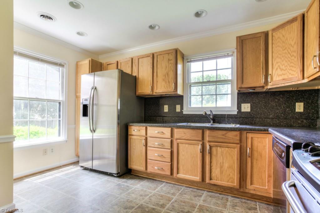 4924 Tower Road, Unit D Greensboro, NC 27410 - Photo 3 of 19 all of these cabinets and still space for your breakfast table. Look at those kitchen windows!