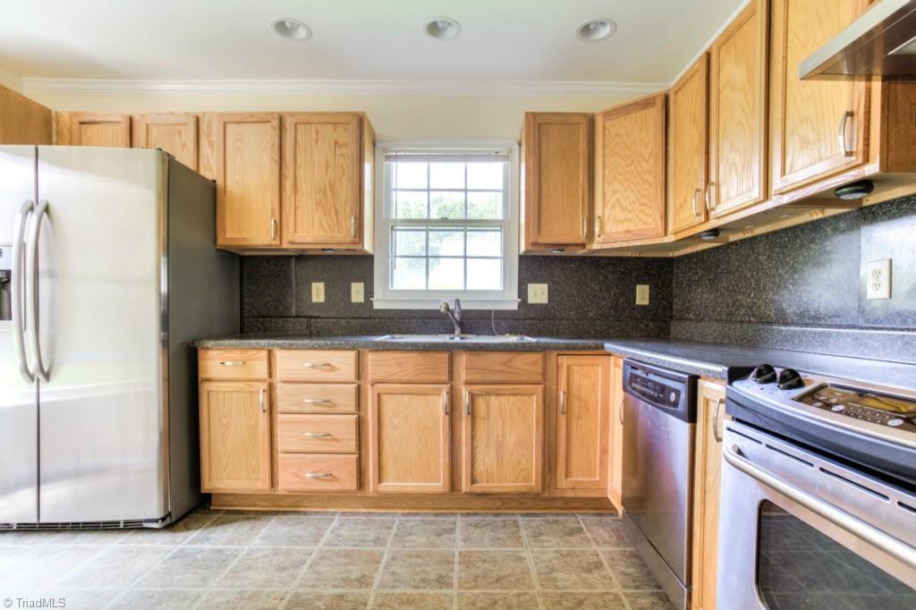 4924 Tower Road, Unit D Greensboro, NC 27410 - Photo 5 of 19 refrigerator remains, just look at all those cabinets