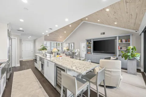 a large white kitchen with a large window