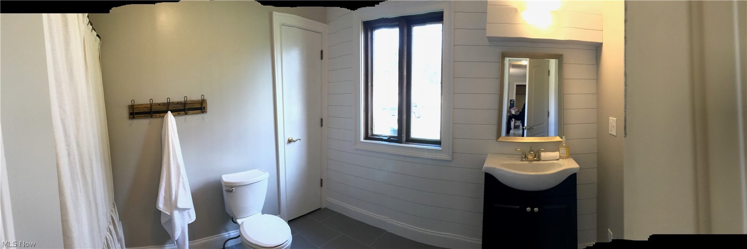 5327 Wedgewood Road Medina, OH 44256 - Photo 9 of 21 SECOND SPACIOUS BATHROOM; FEAUTURES UPDATED VANITY AND COMMODE, WITH A SHIPLAP FEATURE WALL, STONE FLOORING AND A LINEN CLOSET