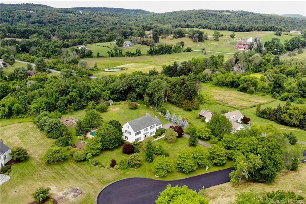 an aerial view of a golf course with a lake view