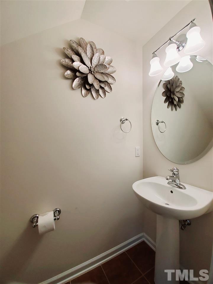 8332 Saltwood Place Raleigh, NC 27617 - Photo 14 of 16 a bathroom with a sink and mirror
