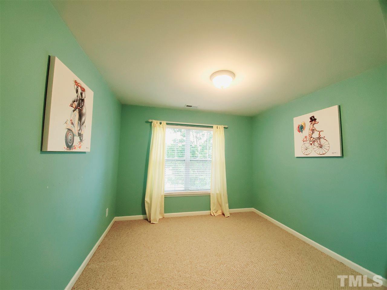 8332 Saltwood Place Raleigh, NC 27617 - Photo 7 of 16 a view of an empty room with a window