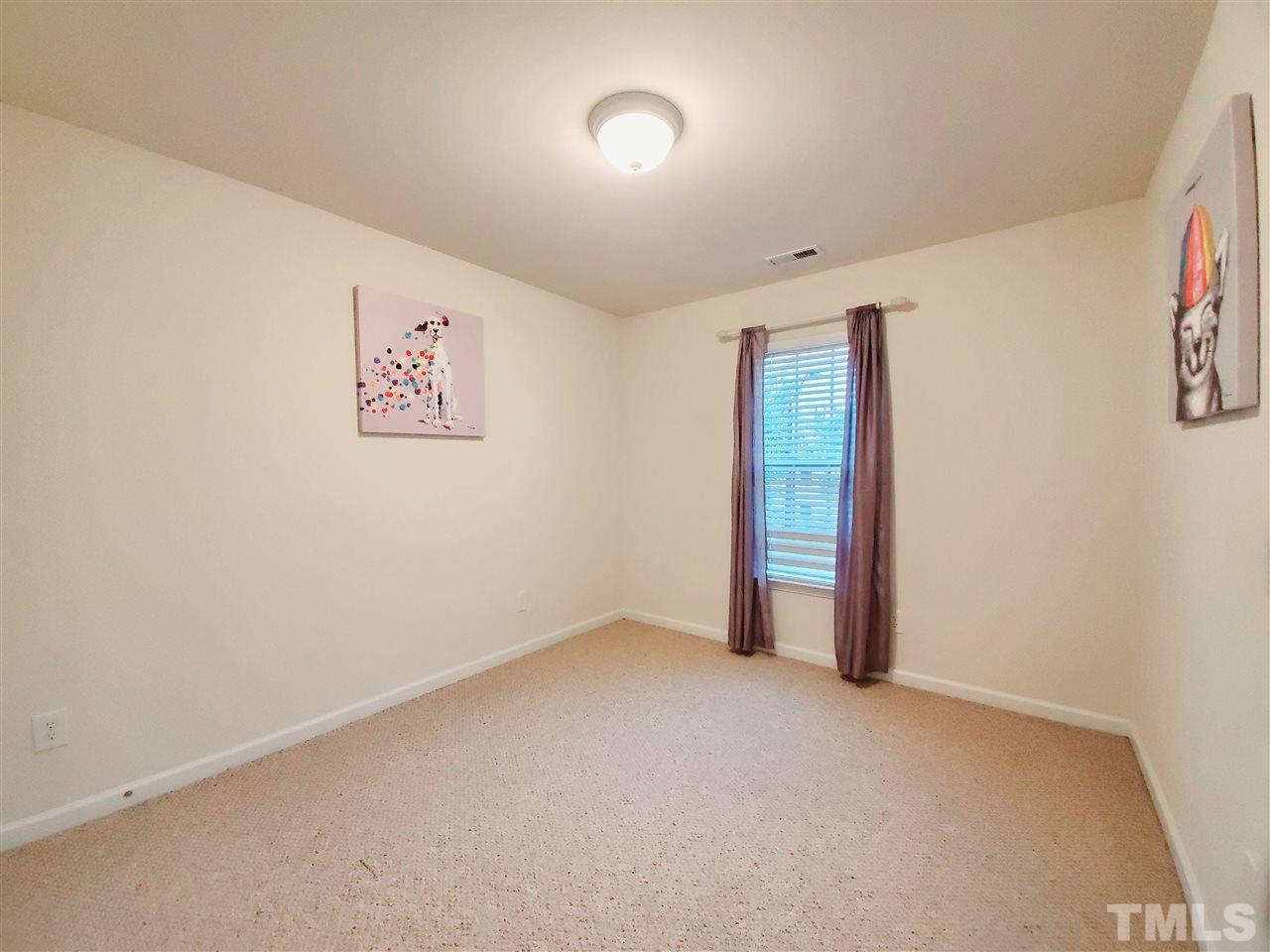 8332 Saltwood Place Raleigh, NC 27617 - Photo 9 of 16 an empty room with an entryway