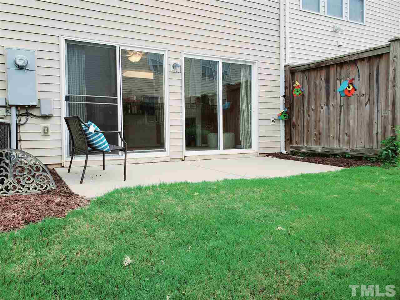 8332 Saltwood Place Raleigh, NC 27617 - Photo 10 of 16 a view of a chair and table in backyard of the house