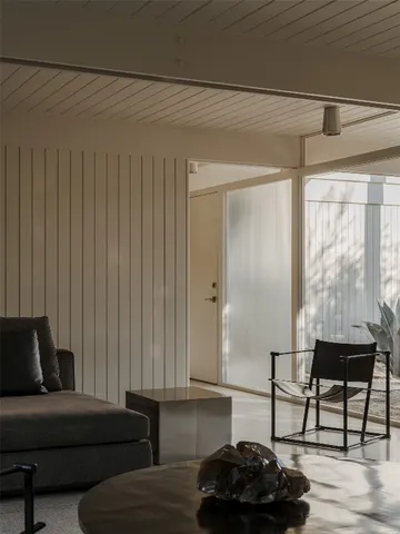 a view of a livingroom with furniture and staircase