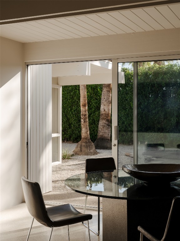 1272 East Verbena Drive Palm Springs, CA 92262 - Photo 27 of 40 a view of a porch with furniture and floor to ceiling window