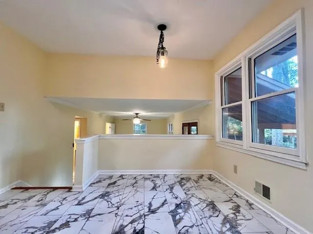 a view of a bedroom with a bed and wooden floor