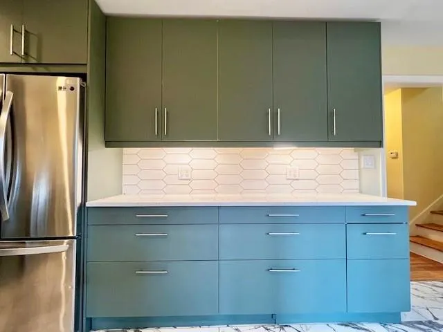 a kitchen with a refrigerator and cabinets