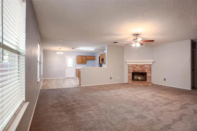 a view of an empty room with a fireplace