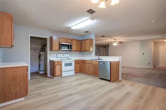 a bathroom with a sink toilet vanity and shower