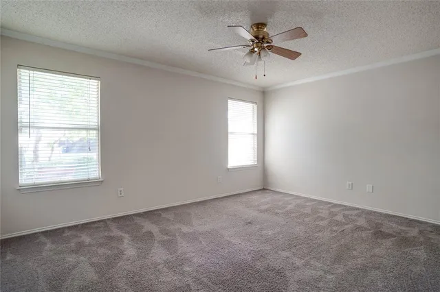 a large kitchen with a large counter top a sink stainless steel appliances and cabinets