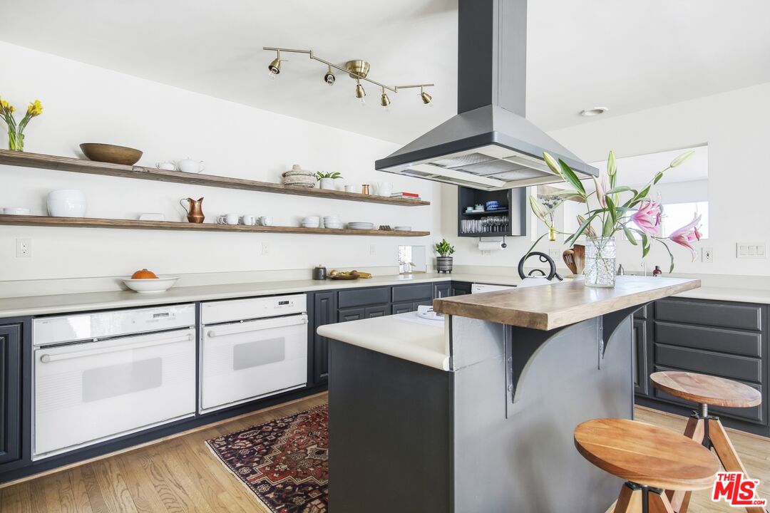 9609 Wornom Avenue Sunland, CA 91040 - Photo 16 of 52 a kitchen with a sink cabinets and wooden floor