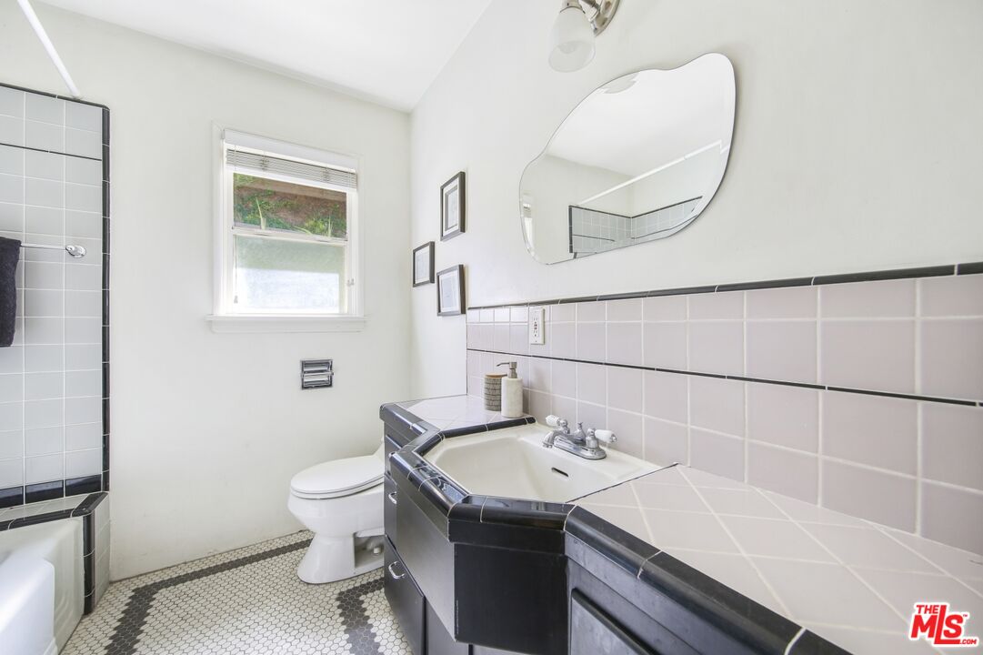 9609 Wornom Avenue Sunland, CA 91040 - Photo 24 of 52 a bathroom with a sink a toilet and a mirror