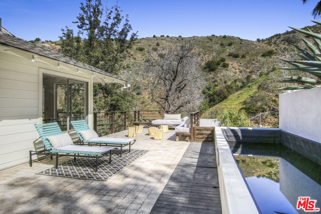 9609 Wornom Avenue Sunland, CA 91040 - Photo 34 of 52 a view of a patio with couches table and chairs and potted plants