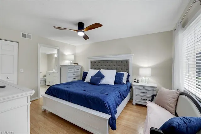 a spacious bedroom with a bed and window