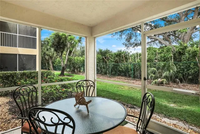 a view of a porch with furniture and garden