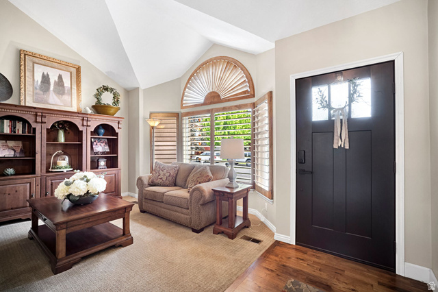 2139 Village Point Way Sandy, UT 84093 - Photo 5 of 35 Vaulted ceiling living area featuring neutral carpet with walnut wood entry way.