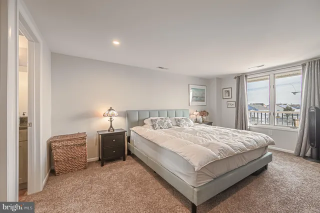 a large bedroom with a bed and large window