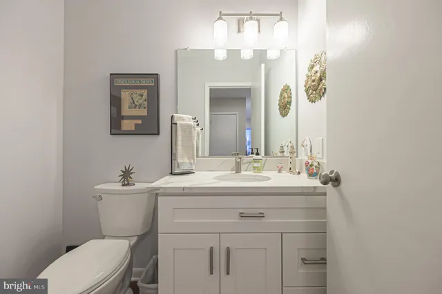 a bathroom with a toilet a sink and mirror
