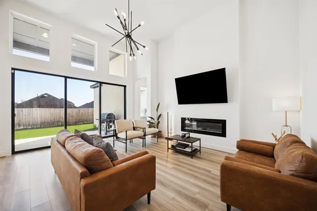 a living room with fireplace furniture and a flat screen tv