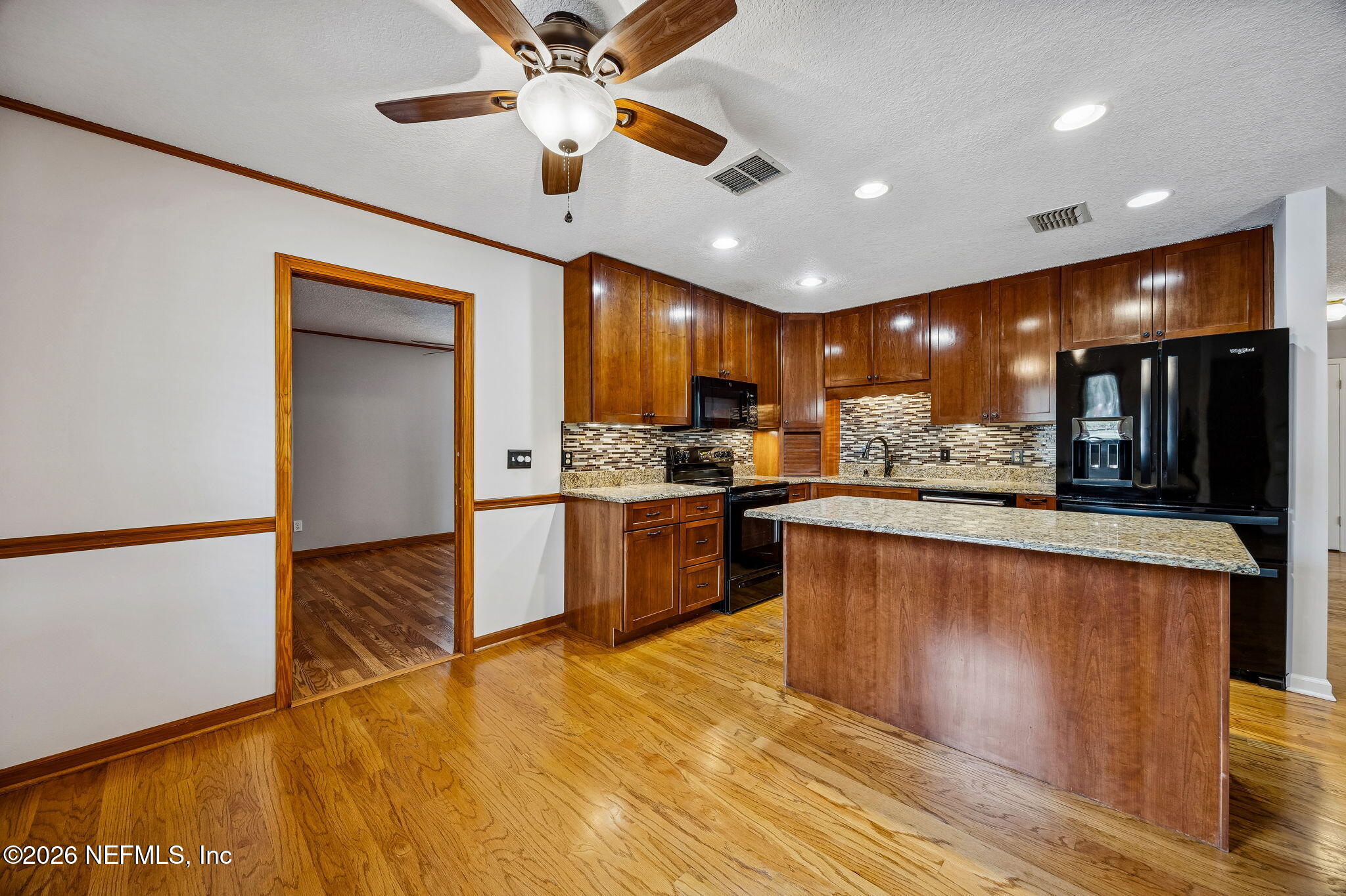 1888 Clemson Road Jacksonville, FL 32217 - Photo 7 of 41 a large kitchen with stainless steel appliances kitchen island granite countertop a refrigerator and a stove top oven