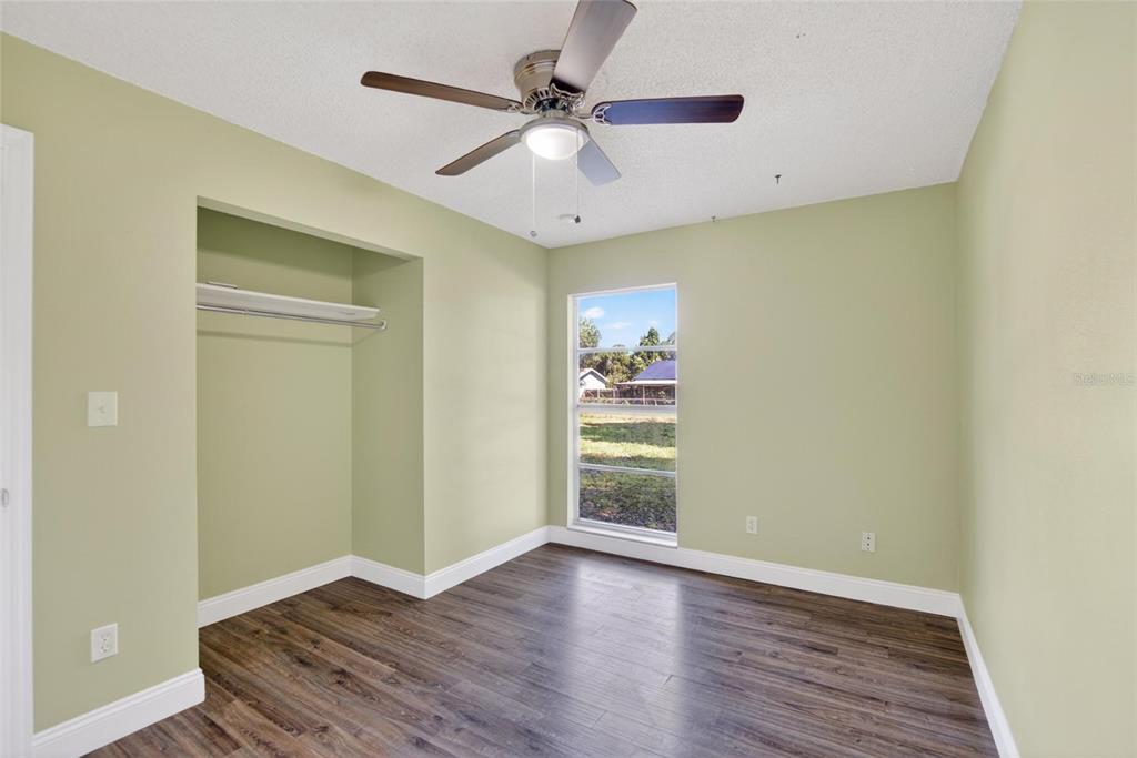 2340 Merrily Circle South Seffner, FL 33584 - Photo 25 of 52 wooden floor in an empty room with a window
