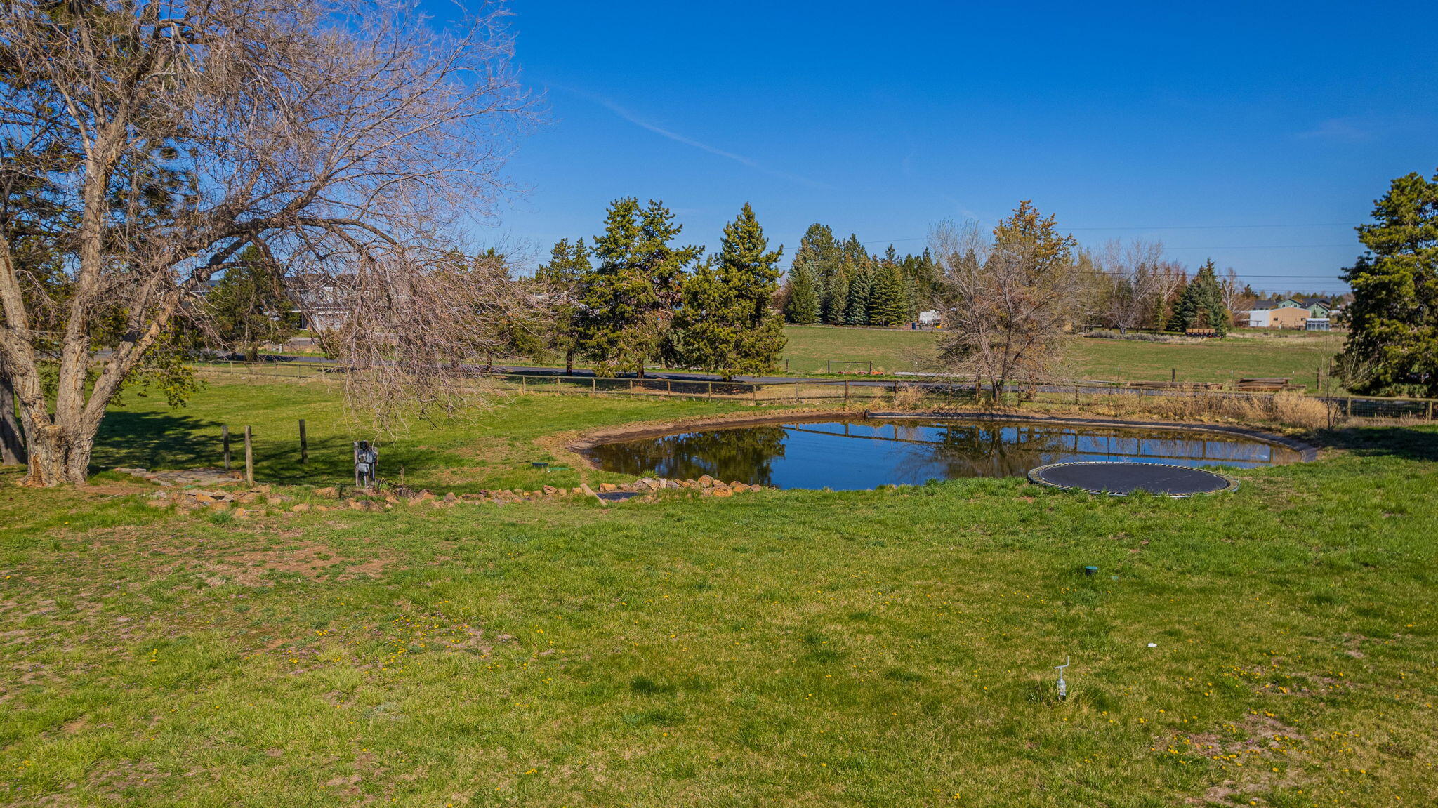 62466 Eagle Road Bend, OR 97701 - Photo 79 of 93 a backyard of a house with lots of green space and lake view