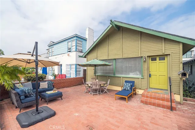 a view of a patio with table and chairs under an umbrella
