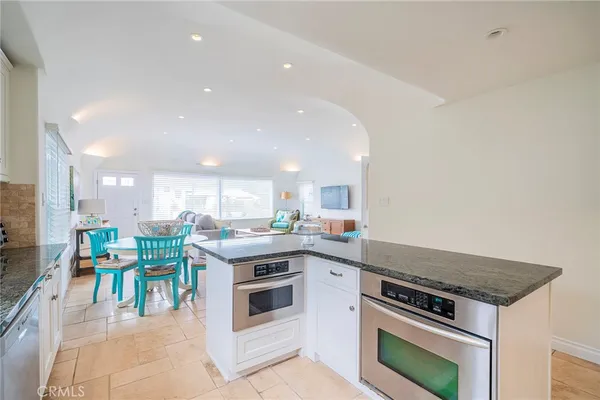 a kitchen with a stove top oven sink and cabinets