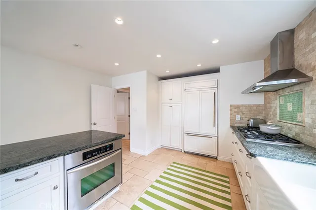 a kitchen with stainless steel appliances granite countertop a stove and a refrigerator