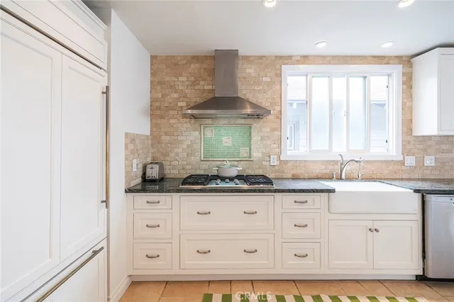 a kitchen with granite countertop a sink and a window
