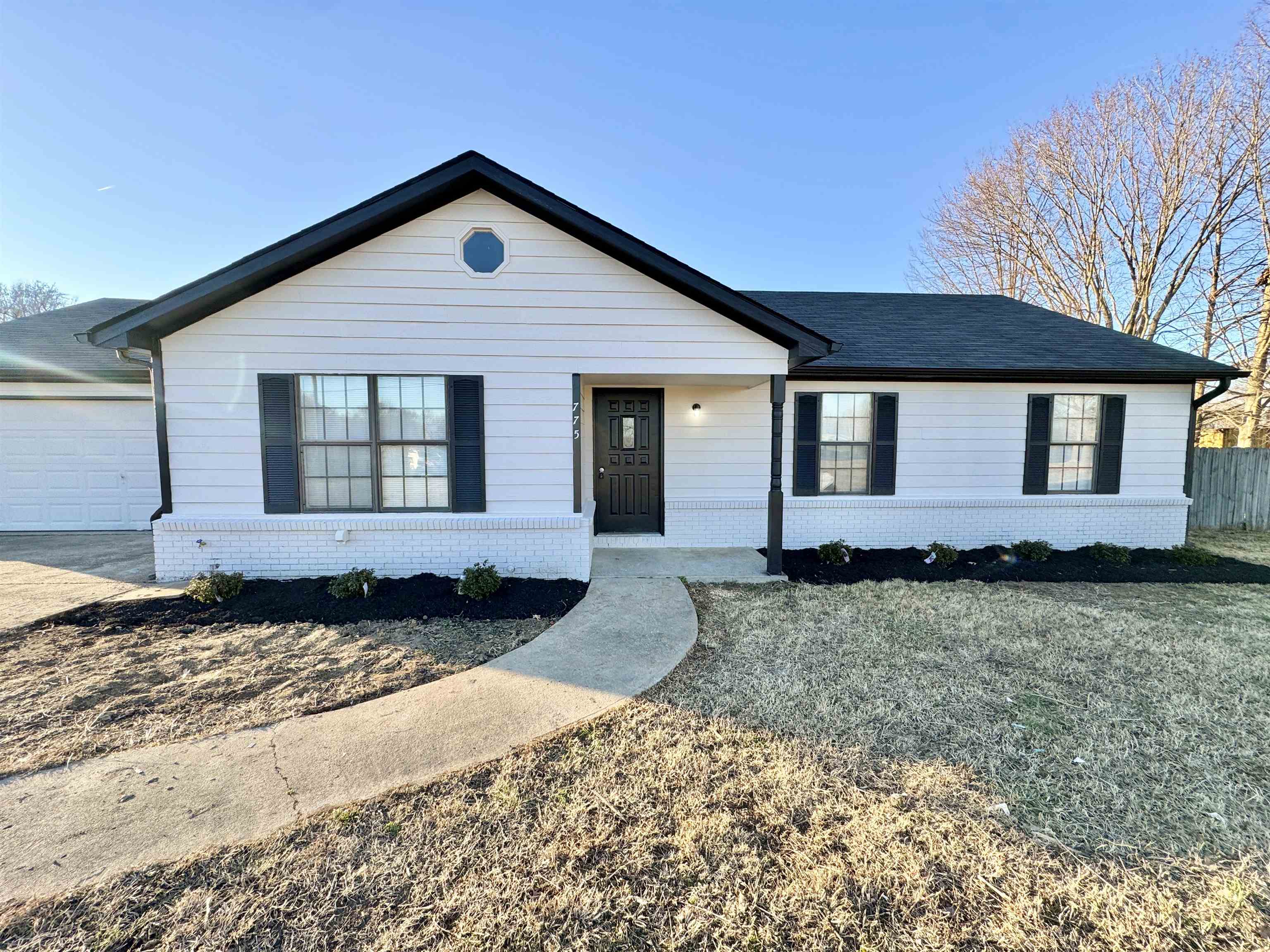 Ranch-style home with a garage and a front yard