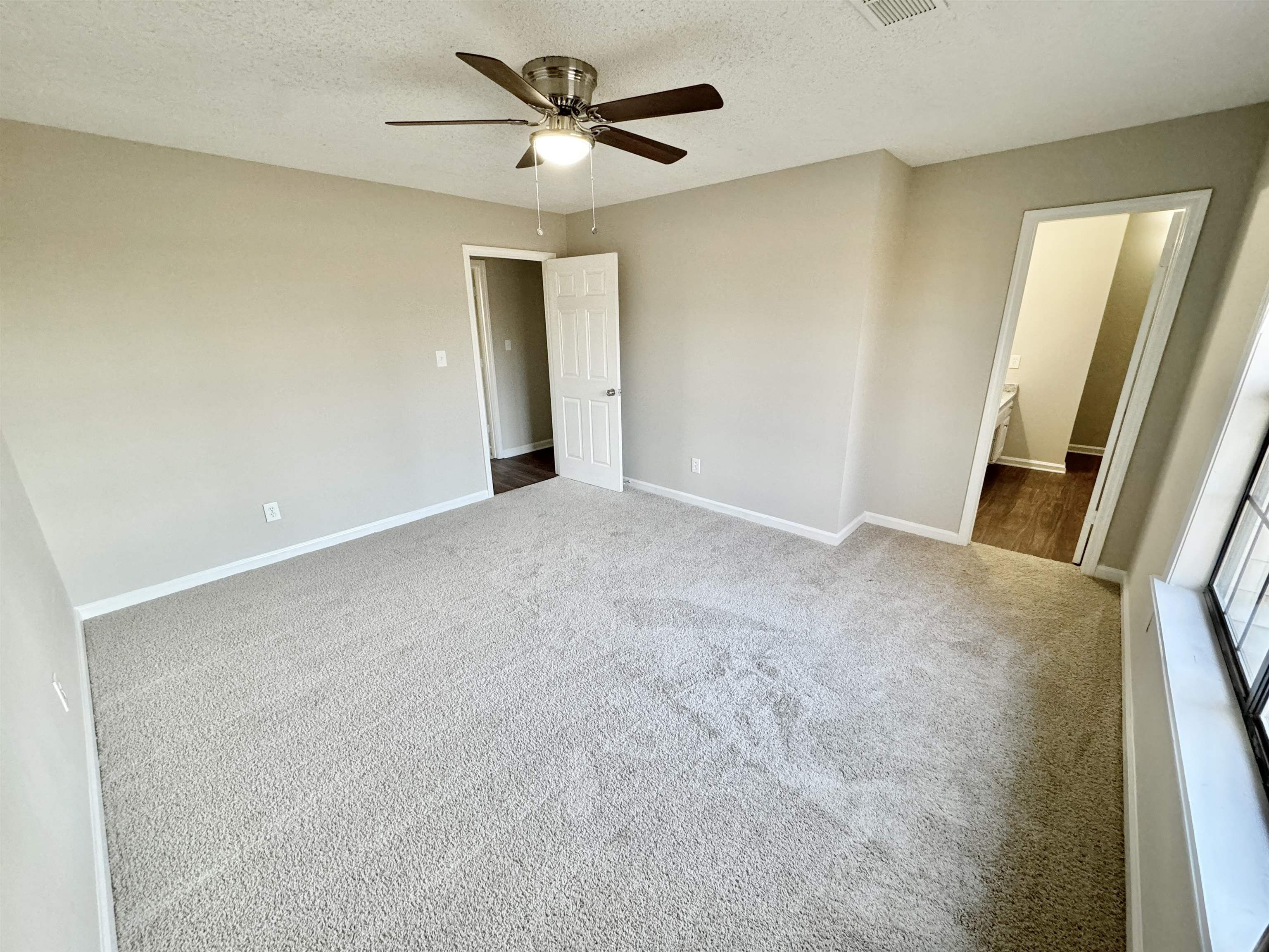775 Portersville Road Atoka, TN 38004 - Photo 15 of 37 Unfurnished bedroom featuring ensuite bathroom, carpet flooring, a textured ceiling, and ceiling fan