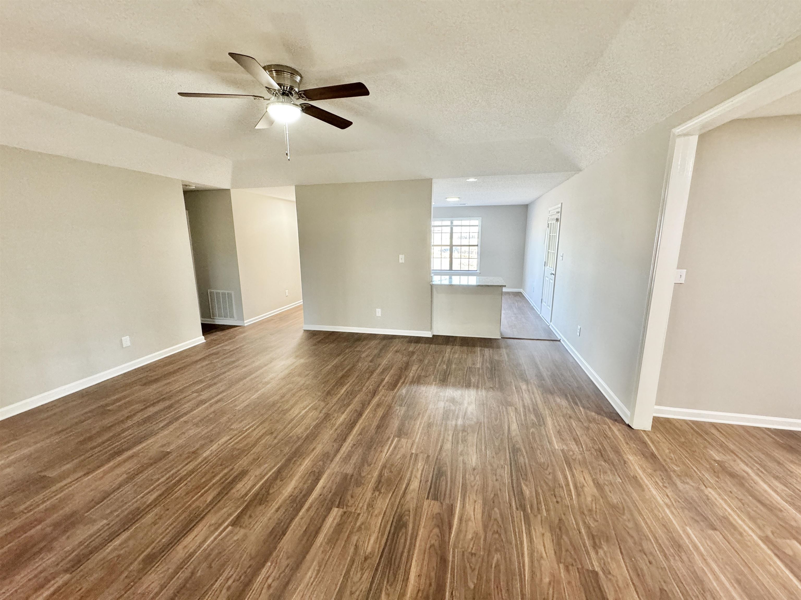 775 Portersville Road Atoka, TN 38004 - Photo 10 of 37 Spare room featuring hardwood / wood-style flooring, ceiling fan, and a textured ceiling