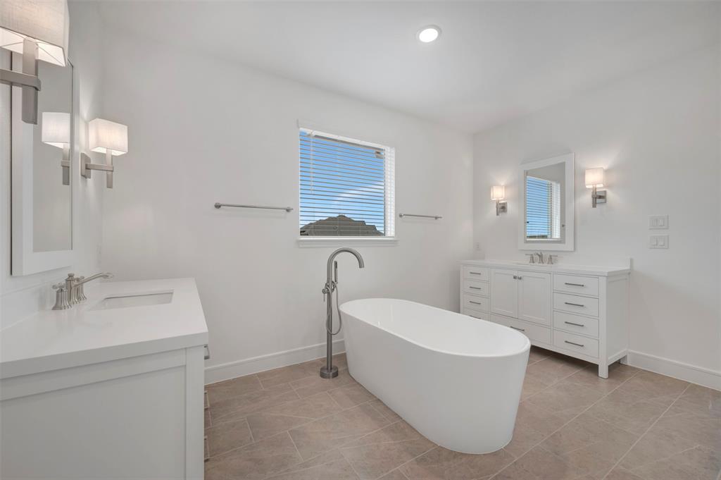 1004 Ashcroft Lane Justin, TX 76247 - Photo 12 of 39 a bathroom with a tub sink and mirror