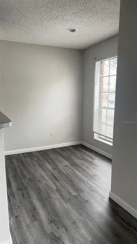 an empty room with windows and entrance