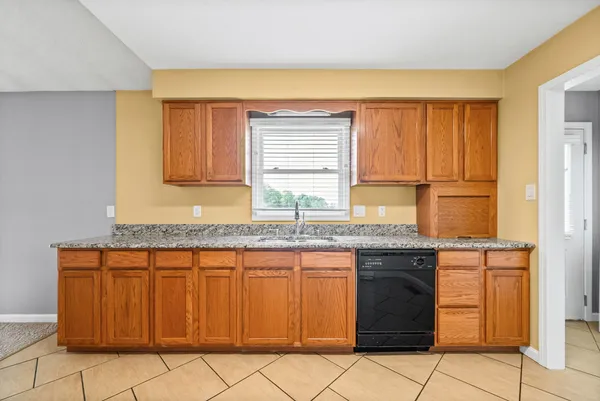 a kitchen with stainless steel appliances granite countertop a sink and a cabinets
