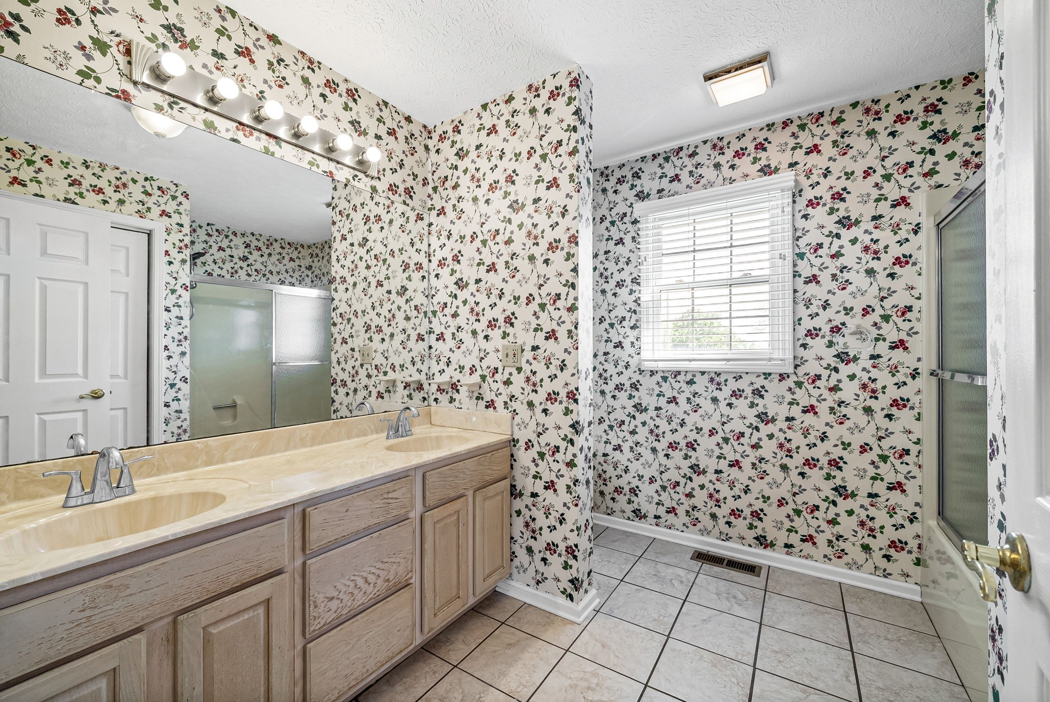 5005 Harmony Grove Road Hopkinsville, KY 42240 - Photo 30 of 41 a spacious bathroom with a sink a toilet a mirror and shower