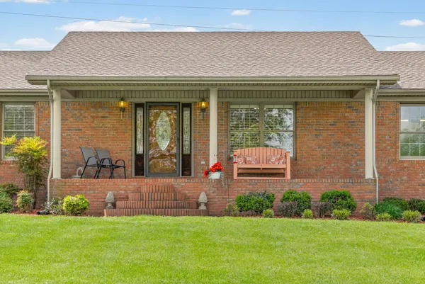 a view of a house with a garden and yard