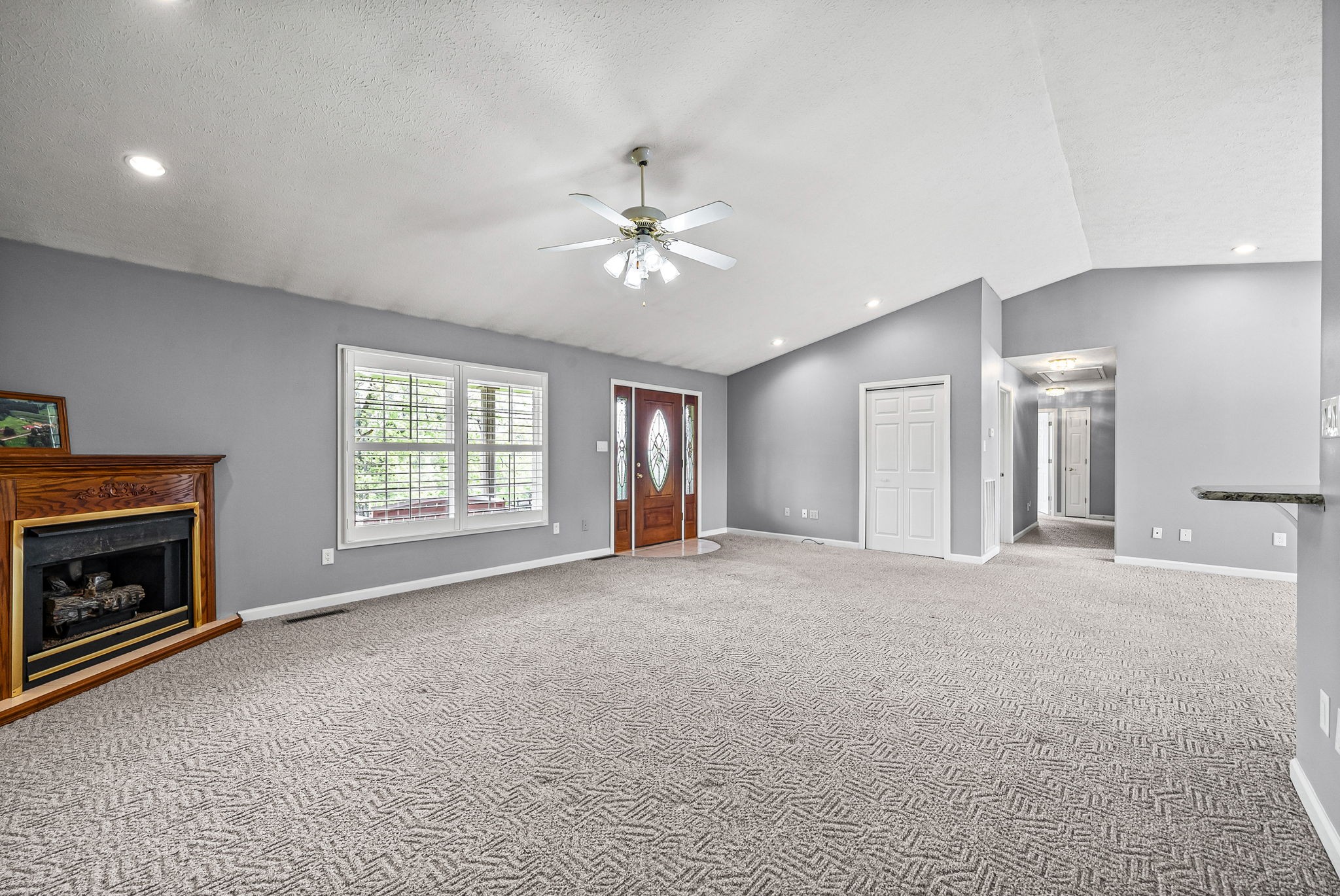 5005 Harmony Grove Road Hopkinsville, KY 42240 - Photo 9 of 41 a view of livingroom and fireplace with ceiling fan