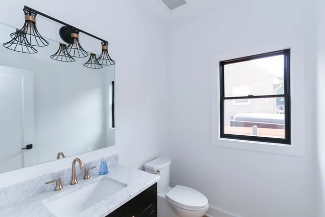 a view of hallway with wooden floor and windows