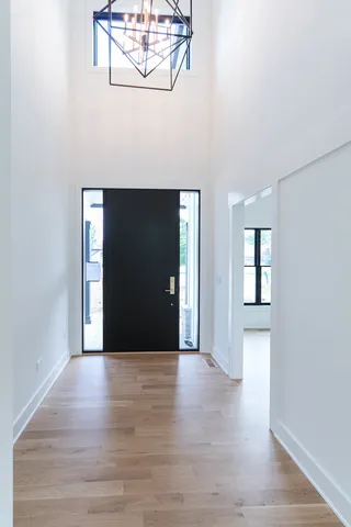 a view of a hallway with wooden floor