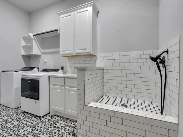 a bathroom with a sink a mirror and shower