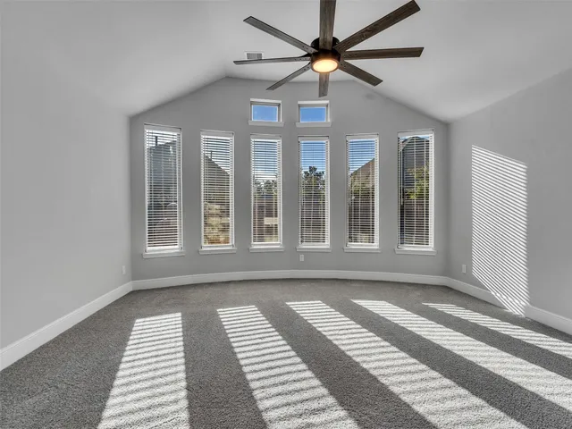 a view of a room with wooden floor and windows