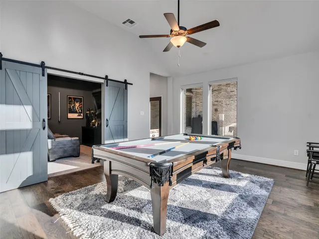 a dining room with wooden floor and window